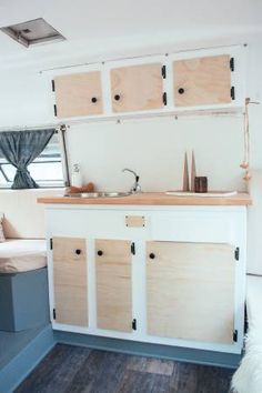 a kitchen area with cabinets and a couch