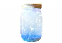 a jar filled with blue liquid sitting on top of a table