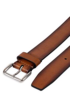 Burnished edges adds a rustic appeal to a stylish leather belt fitted with a soft rounded buckle for a casual finish. 1 1/2" belt width Leather Imported Rustic Leather Belt With Antique Buckle, Distressed Brown Leather Belt With Antique Buckle, Rugged Distressed Brown Leather Belt, Rustic Leather Belt Buckle With Removable Belt, Rugged Leather Belt With Removable Feature, Rugged Brown Bridle Leather Belt, Rugged Leather Belt With Antique Buckle, Rugged Leather Belt, Classic Leather Belt Buckle In Distressed Brown