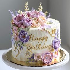 a birthday cake decorated with flowers and the words happy birthday