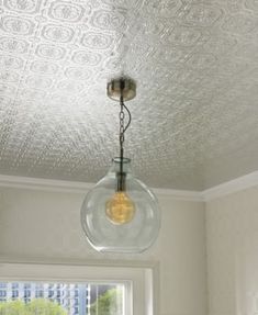 a light fixture hanging from the ceiling in a kitchen