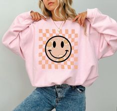 Smiling Flower Sweatshirt, Retro Smiley Face Shirt, Trendy Graphic Shirt, Boho Smile Shirt, Birthday Gift,Trendy Smile shirt, Welcome to CustomTeeChicca Store. "We want to know, design and print what you imagine. " - We design, print and press our products. - Our design will be made with Direct to Film technology. - If you want to add or change anything to the existing design that we show in the screenshot, please contact us. - If you enter the wrong address with your order, we will try to help Long Sleeve Cartoon Print Relaxed Fit Shirt, Spring Cartoon Print Relaxed Fit Shirt, Relaxed Fit Long Sleeve Shirt With Cartoon Print, Fun Long Sleeve Printed Tops, Trendy Long Sleeve T-shirt With Cartoon Print, Graphic Tee Shirt With Cartoon Print, Trendy Printed Crew Neck Sweatshirt, Spring Funny Print Long Sleeve Tops, Fun Long Sleeve T-shirt For Spring