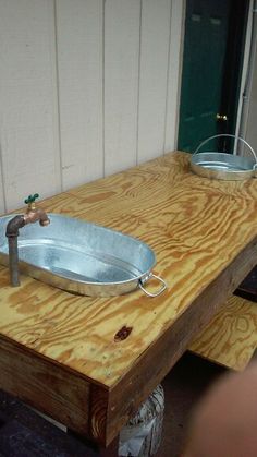 a large metal bowl sitting on top of a wooden table next to a fire hydrant