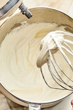 a whisk is being stirred in a mixing bowl