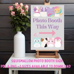 a photo booth sign next to a vase with flowers in it and an easel