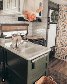 a kitchen with a sink, stove and oven