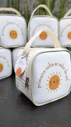 four white lunch boxes sitting on top of a table