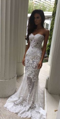 a woman in a white wedding dress standing on the porch with her hand on her hip