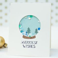 a card with a snow globe on it and the words merriest wishes in blue