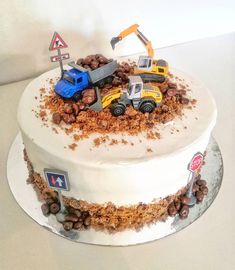 there is a cake with cars on it and chocolate chips all over the bottom layer