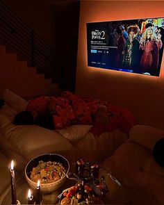 a living room filled with furniture and a flat screen tv mounted to the side of a wall