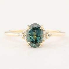 an oval cut green sapphire and diamond ring