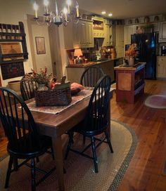 a dining room table with chairs and a basket on the table in front of it