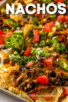 nachos with cheese, black beans and peppers on top