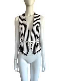 1990s Moschino Cheap and Chic black and white shoe laces stripe vest Ties at waist Lined Marked size 42 (IT) Best fit: S Made in Italy Condition: Very good (no particular flaw) Measurements (taken flat): Shoulders: 17 cm / 6,5" Armpits: about 41 cm / 16" Waist (adjustable): about 40 cm / 15,5" Front length: 56 cm / 22" Back length: 50 cm / 19,5" - -- CONDITION GLOSSARY -- -- DEADSTOCK: the item is new, never be worned and it still has the label tag. EXCELLENT: the item is like new, it has no fla Chic Striped Summer Vest, Chic Fitted Striped Vest, Chic Striped Spring Vest, Spring Workwear Vest With Vertical Stripes, Sleeveless Vest With Vertical Stripes For Spring, Stripe Vest, Striped Vest, White Shoe, Striped Vests