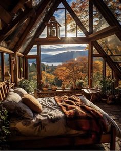 a bed sitting under a window in a bedroom next to a wooden floor and ceiling