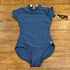 Maria Crown Smocked Neck Leotard Size Small One-piece Stretch Tops For Swimming, Blue High Stretch Bodysuit For Swimming, High Stretch Blue Bodysuit For Swimming, Stretch Blue Bodysuit For Swimming, Blue Stretch Leotard For Summer, Navy Stretch Bodysuit For Swimming, Fitted Blue One-piece Leotard, Blue Stretch Nylon Tops, High Stretch Blue Nylon Bodysuit