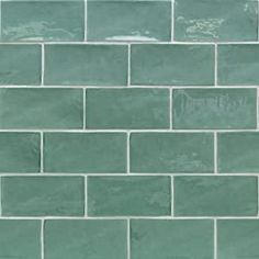 a close up view of a green tile wall