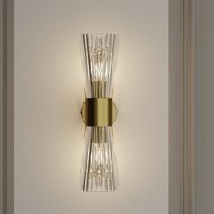 a wall light that is mounted on the side of a wall in a room with white walls