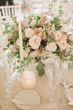 an elegant table setting with candles and flowers