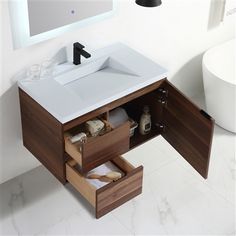 a bathroom vanity with drawers and a mirror above it