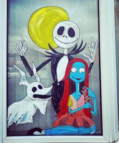 a window with a painting of jack skellingy and the skeleton girl on it