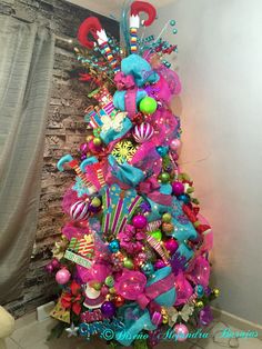 a brightly colored christmas tree with decorations