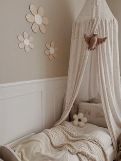 a child's bedroom with a canopy bed and stuffed animals