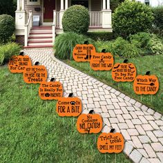 halloween yard decorations with orange pumpkins on the front lawn and words written in black