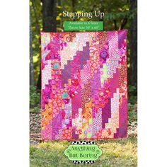 a colorful quilt on the grass with trees in the background and text saying, stepping up available