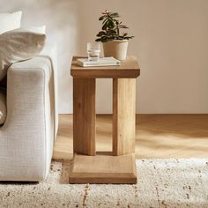 a living room with a couch, chair and table on the floor in front of it