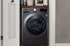 a washer sitting inside of a closet next to a door