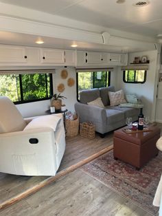 a living room filled with furniture and windows