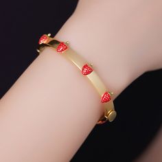 Add a touch of vintage charm to your wrist with the Vintage Strawberry Bracelet. Crafted from 18k gold on brass with exquisite enamel detailing, this bracelet showcases a delightful design inspired by strawberries. Whether worn as a gift or for dinner parties or everyday wear, it brings a playful elegance to any occasion. Embrace the sweet nostalgia with this captivating bracelet that captures the essence of vintage allure. DETAILS Plating: 18K Gold Materials: 18K Gold on Brass, Enamel Measureme Strawberry Bracelet, Fruit Bracelet, 18k Gold Bangle, Gold Bangles For Women, Unique Gift Wrapping, Vintage Strawberry, Cuban Link Chain Necklaces, Hand Necklace, Opal Pendant Necklace