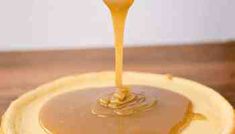 a pancake covered in syrup being drizzled with honey