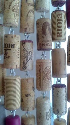 several wine corks are hanging on the wall