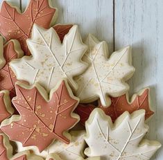 some cookies decorated with leaves are sitting on a table