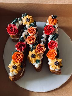 there are many flowers on the top of these cupcakes that have been made to look like letters