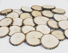 several pieces of wood that have been cut into smaller circles and are sitting on a white surface