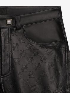 Partially monolink embossed leather pants, black and gold button, engraved gold zipper fly closure, classic four-pocket tailoring, and signature black leather badge at back. -Body: 100% Leather -Color: Black -Slightly Wider Hips / Tighter Ankles -Model is 6'1'' / 185cm and wears M / 32-33 -Care: Leather specialist only | Hang for storing -Made in Turkey Designer Black Bottoms With Belt Loops, Luxury Leather Pants With Belt Loops For Formal Wear, Luxury Leather Pants With Belt Loops For Formal Occasions, Luxury Leather Pants With Belt Loops For Formal Events, Designer Black Leather Bottoms, Luxury Black Leather Bottoms, Luxury Black Leather Pants For Work, Luxury Black Leather Pants, Luxury Fitted Leather Pants