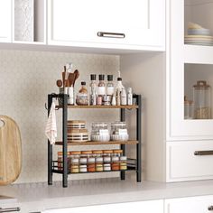 a kitchen with white cabinets and shelves filled with various types of confective items