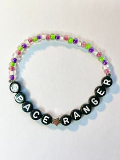 a beaded bracelet with the word space ranger written in black and white letters on it