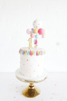 an instagram page with a cake on it and balloons in the top tiers