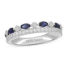 a white gold ring with blue sapphires and diamonds on the sides, set in 18k white gold