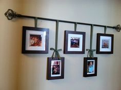 four framed pictures hang on a wall with ribbons