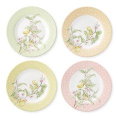 four plates with different designs on them, one has lemons and the other has flowers