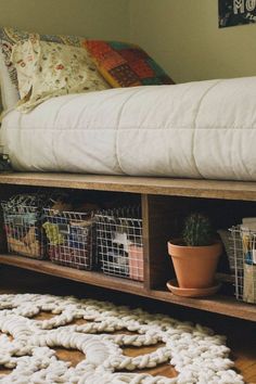 a bed sitting on top of a wooden shelf