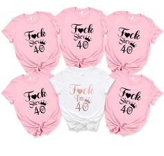 pink and white shirts with the words teach time 40 written on them in different font styles