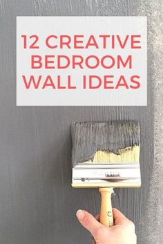 a hand holding a paintbrush with the words 12 creative bedroom wall ideas on it