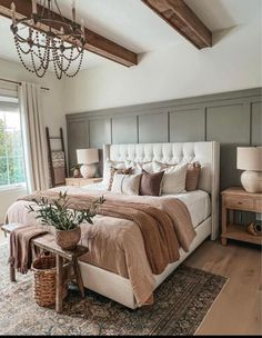 a bedroom with a large bed and chandelier